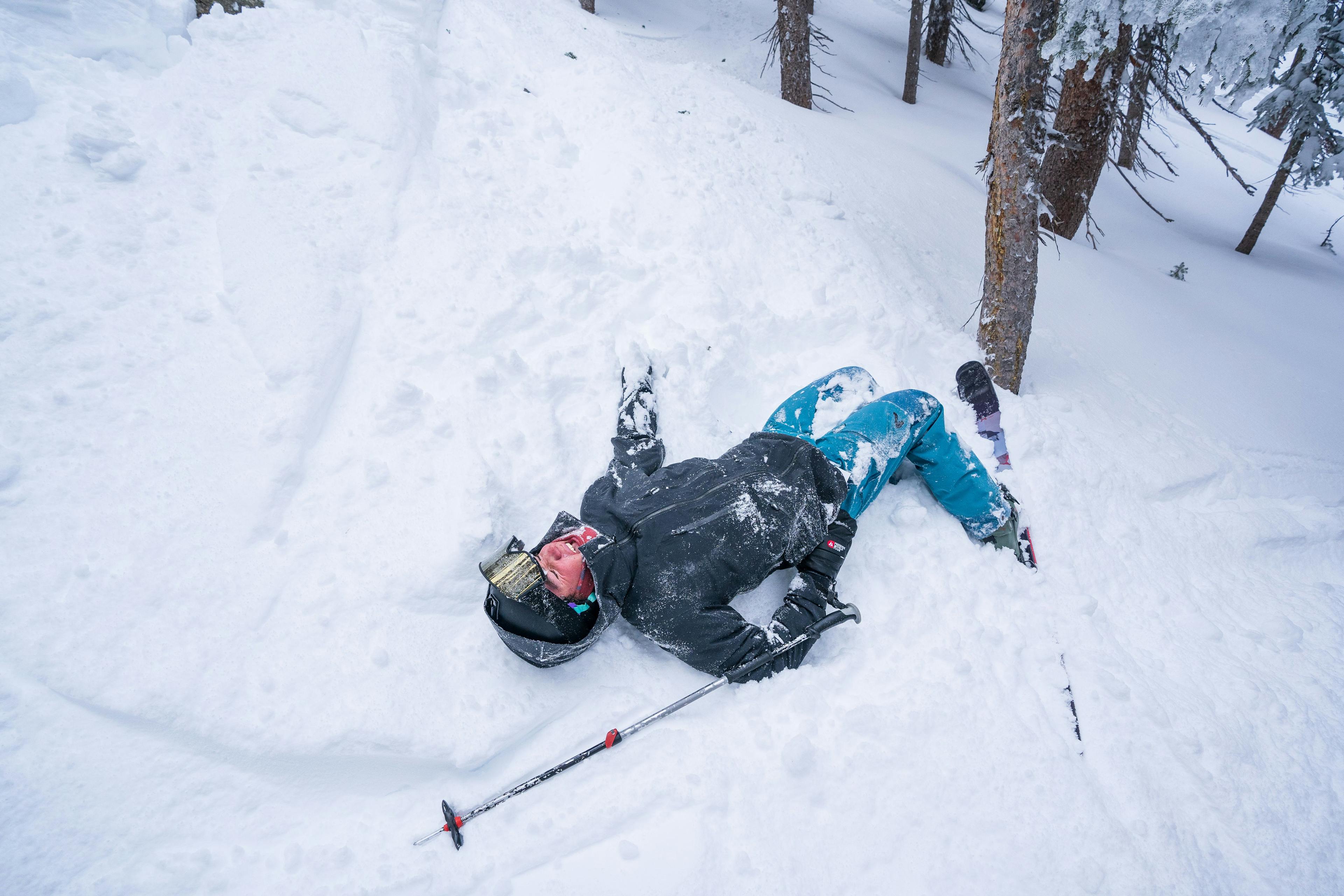 Skier laying in the snow after a crash landing