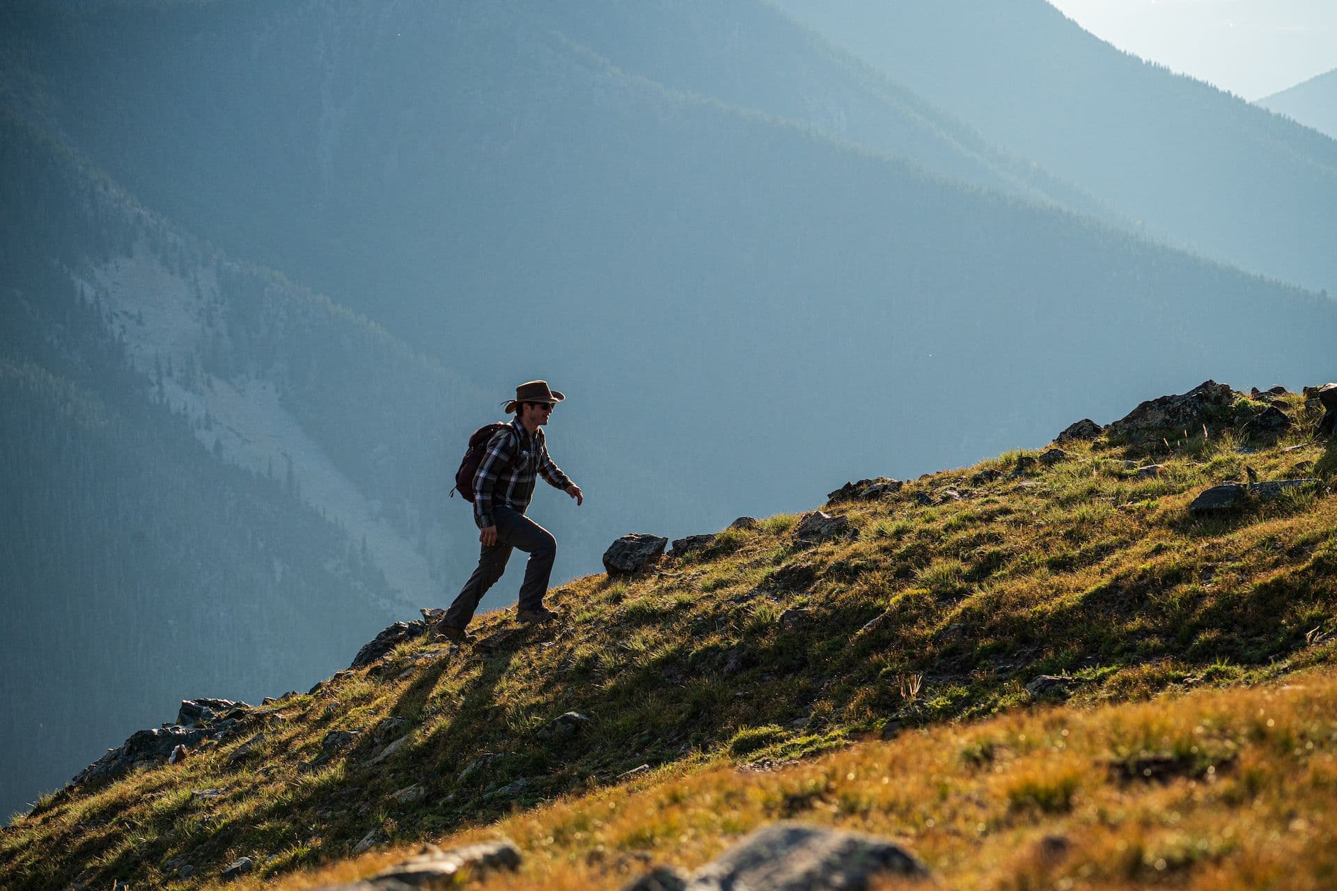 Hiker walking up a trail at Taos Ski Valley.