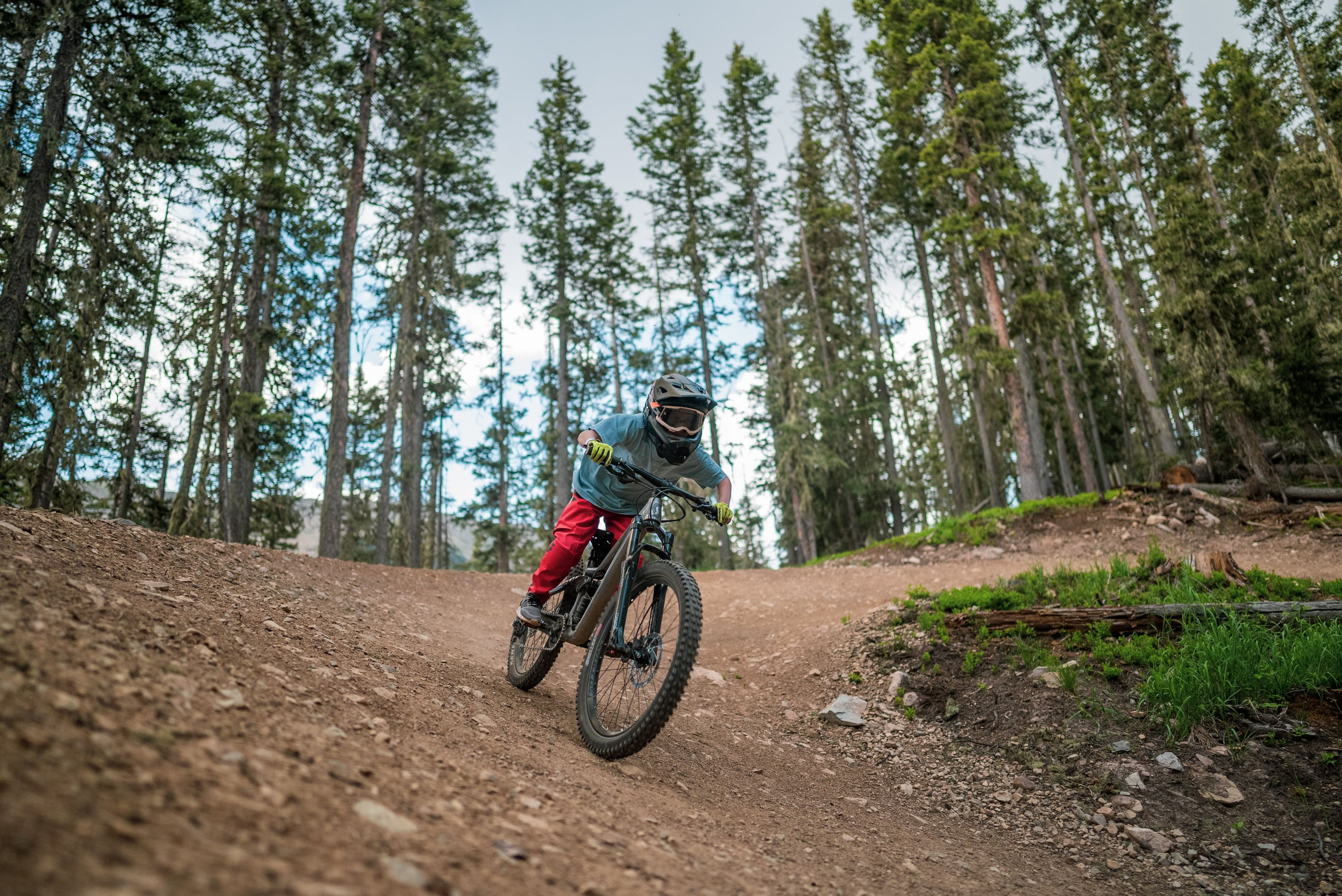 Young mountain biker heads down a trail in the bike park at TaosSki Valley