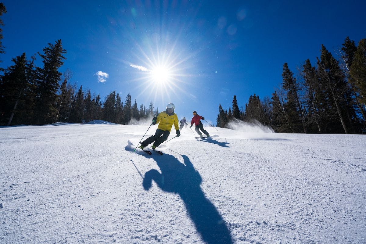 A ski instructor teaches a group how to carve at Taos Ski Valley.