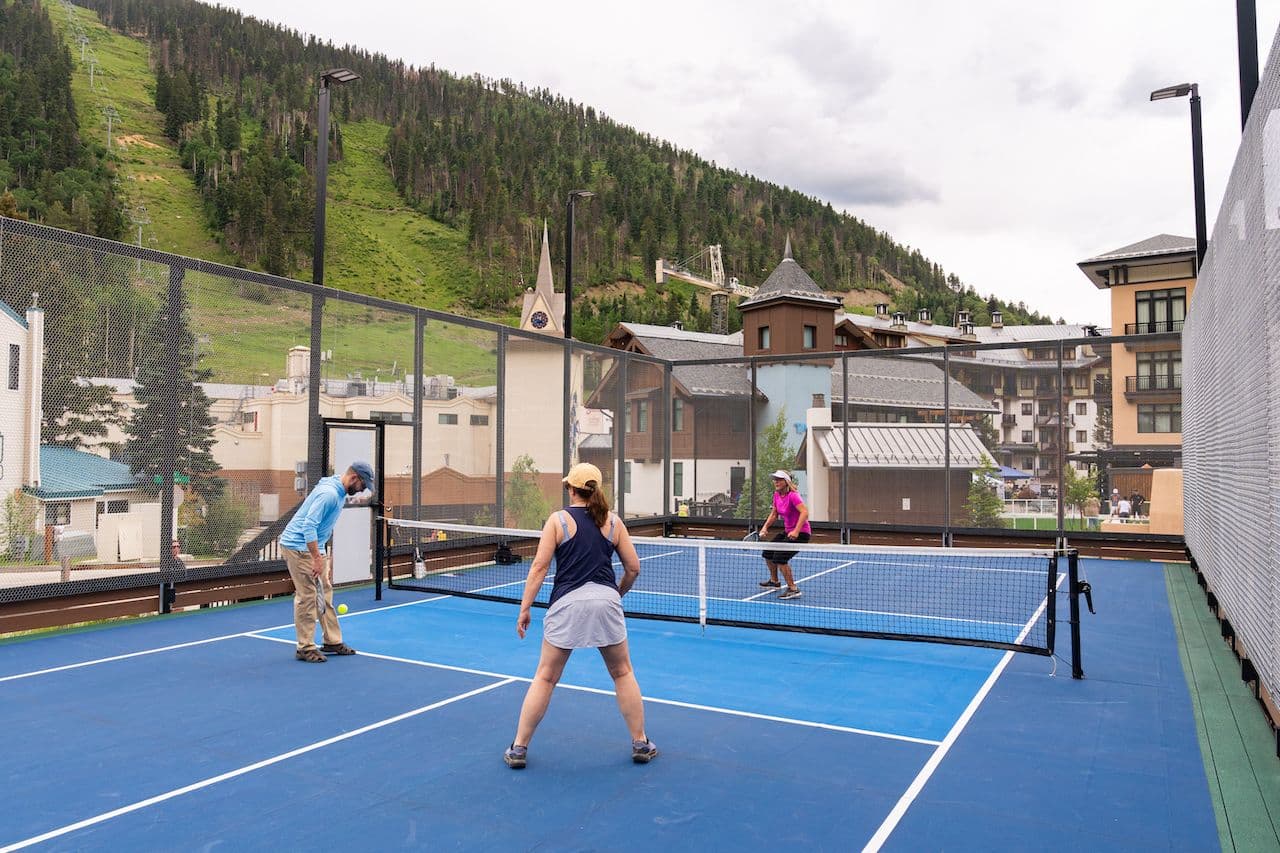 Two teams of two playing pickleball at a court in Taos Ski Valley.