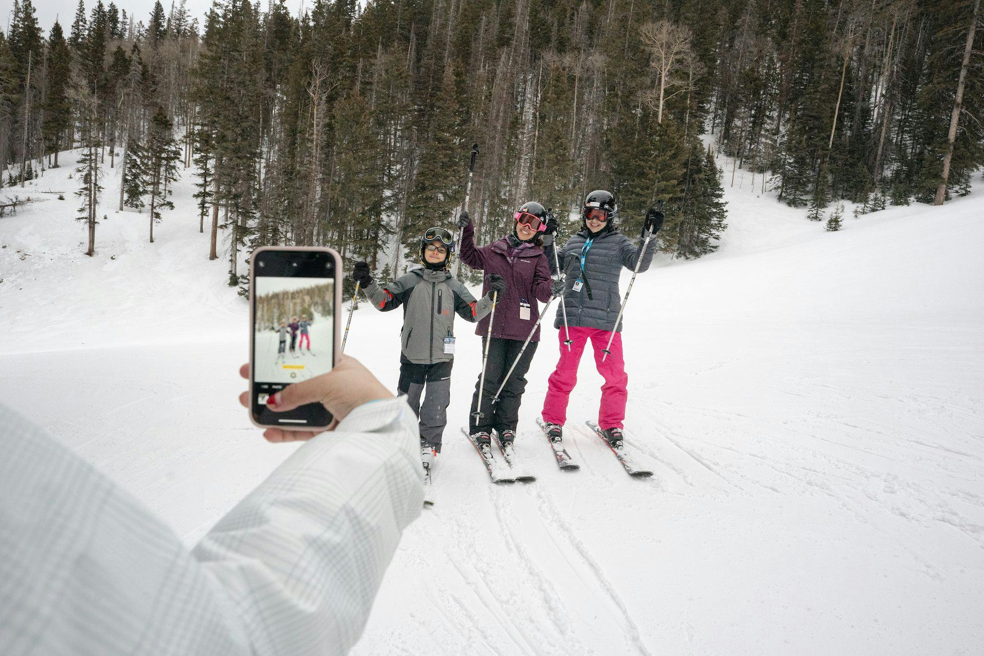 Group of teen skiers taking a selfie mid-slope at Taos Ski Valley