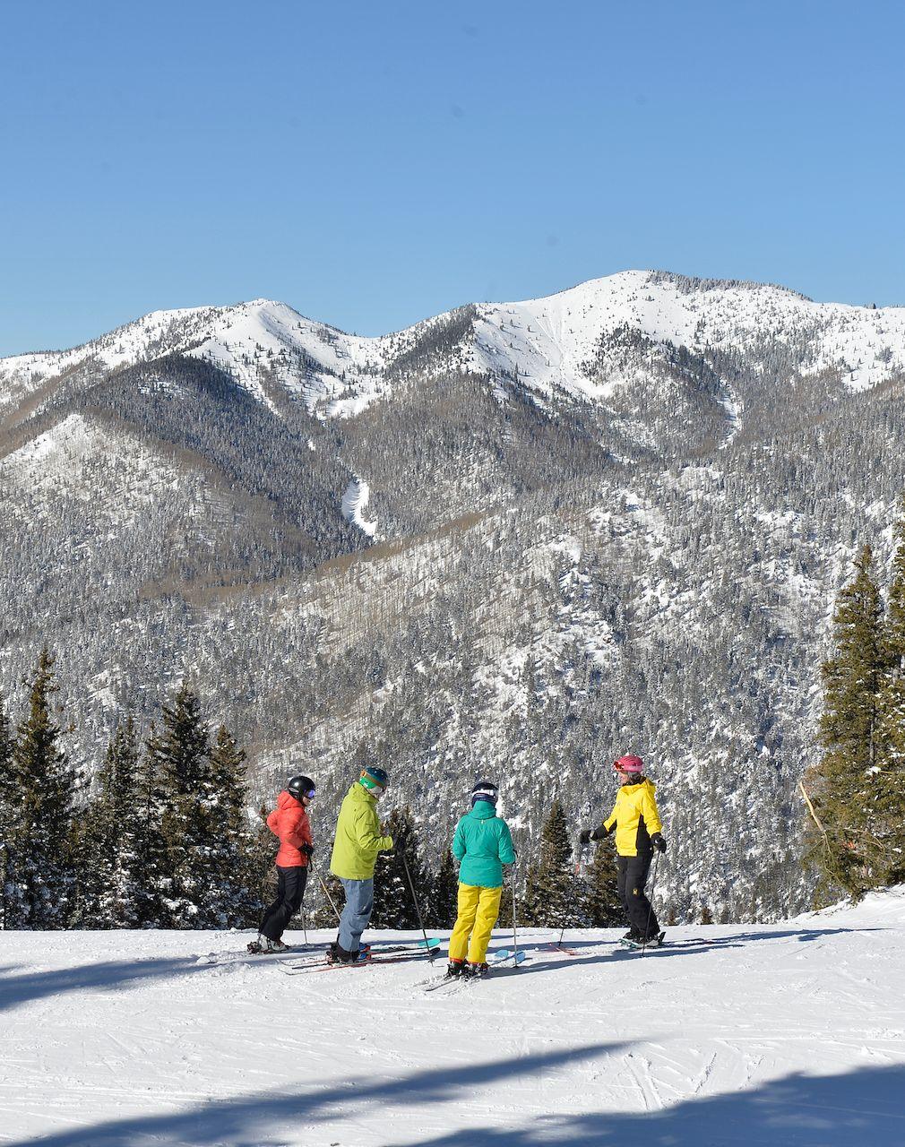 Family of skiers taking a ski lesson at Taos Ski Valley