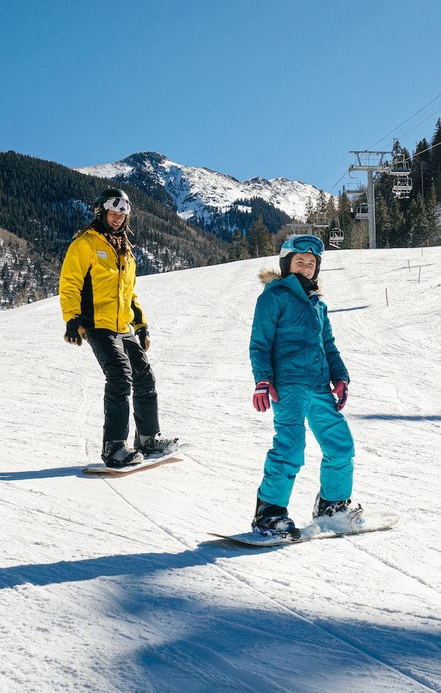 Teenage snowboarder taking a lesson at Taos Ski Valley