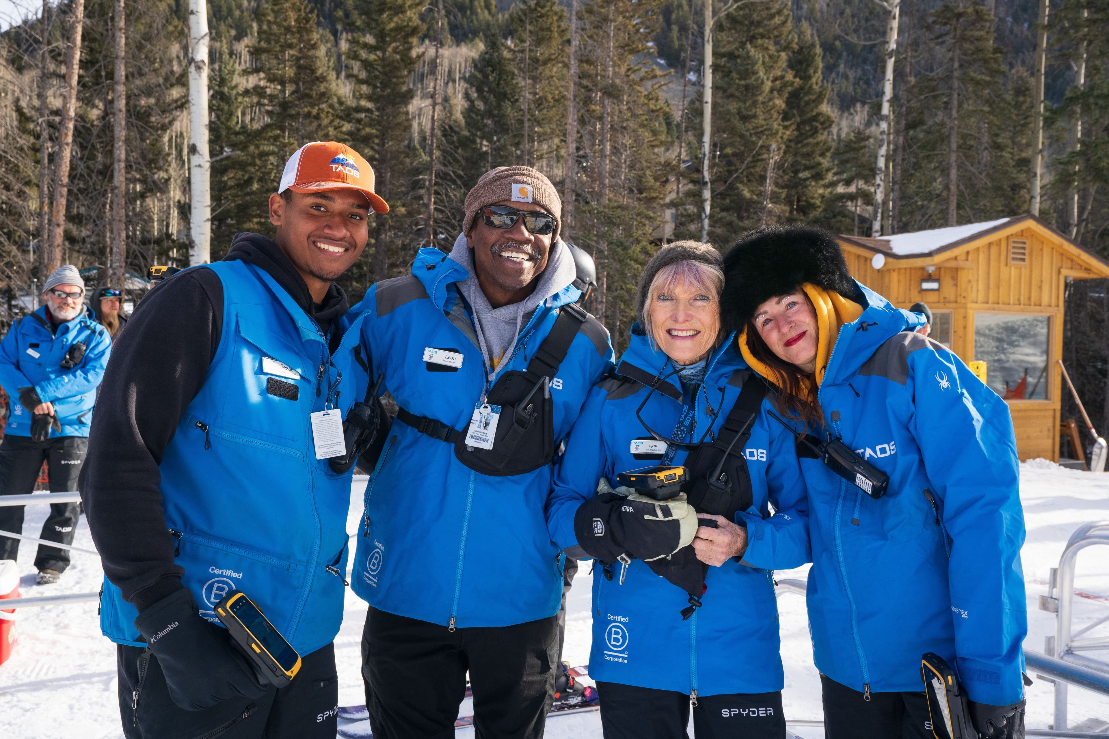 Four Taos Ski Valley employees pose in front of the beginner learning area.