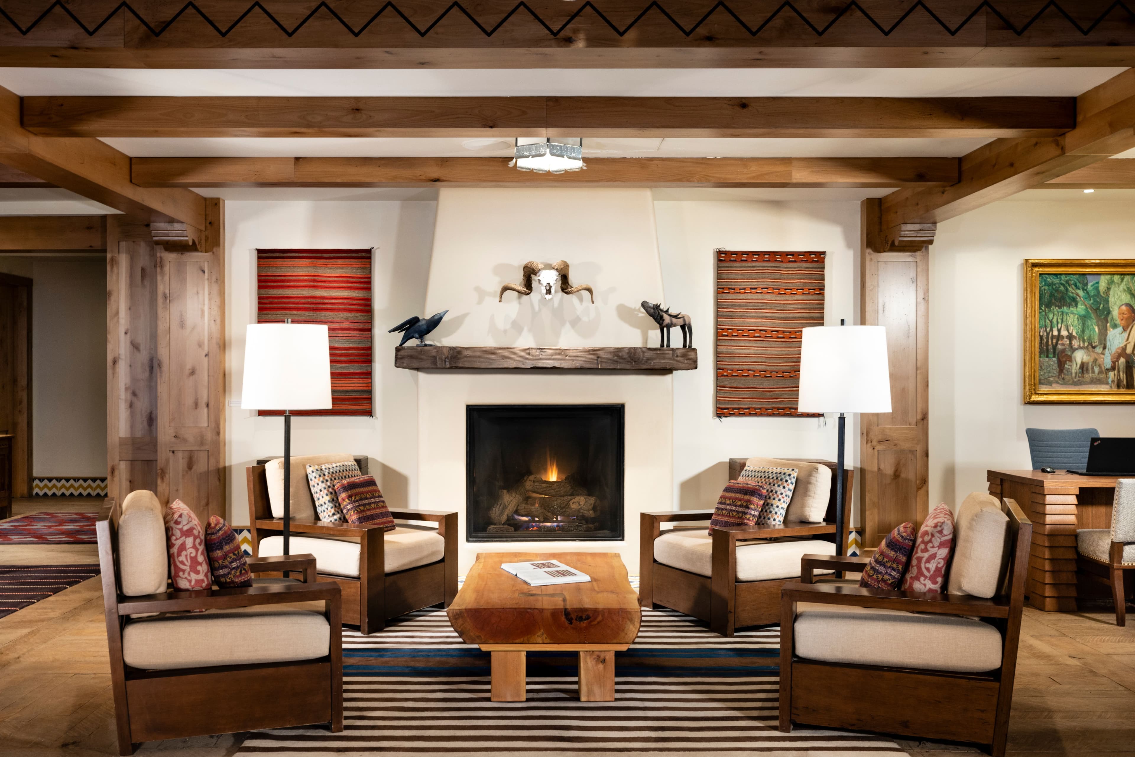 Lobby of The Blake hotel featuring four chairs in front of a fireplace.